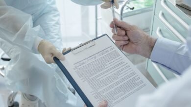Paciente recebendo documento de profissional de saúde em consultório médico, representando plano de saúde